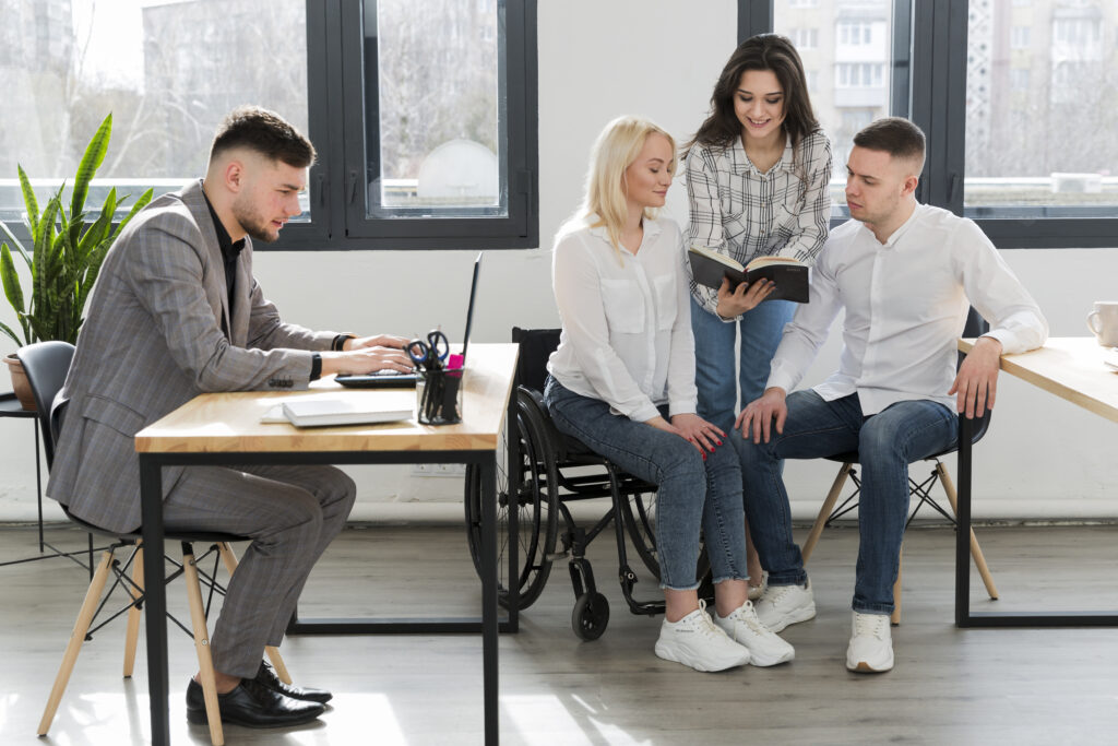 woman-wheelchair-conversing-with-coworkers-office